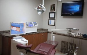 Modern dental treatment room equipped with advanced technology and patient care equipment