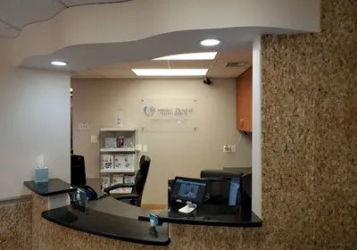 Dental office reception area with front desk and patient check-in counter